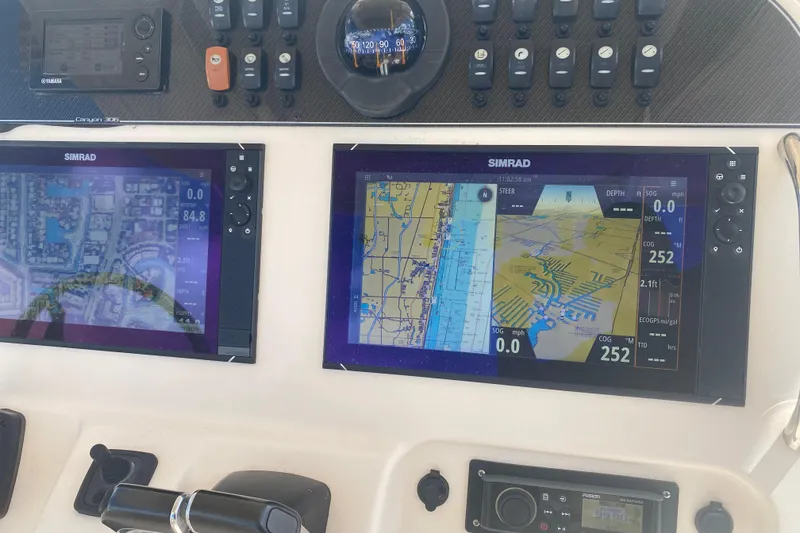 Slide: The Image of Dashboard of a 2018 Grady-White Canyon 306 with Simrad navigation displays. - 9