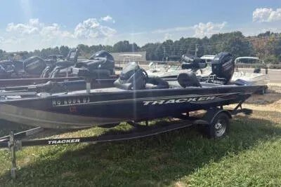 Slide: The Image of 2019 Tracker Pro Team 175 TF boat on trailer, parked outdoors under a sunny sky. - 3