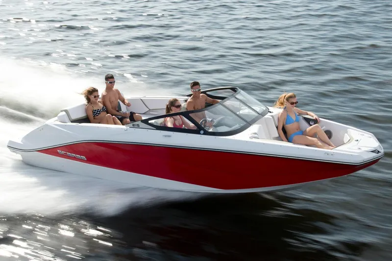 The Image of 2015 Scarab 215 boat in showroom, red and white design, on trailer, Yamaha sign above. - 0