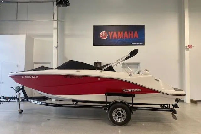 Slide: The Image of 2015 Scarab 215 boat interior with white seating and carpeted floor. - 11