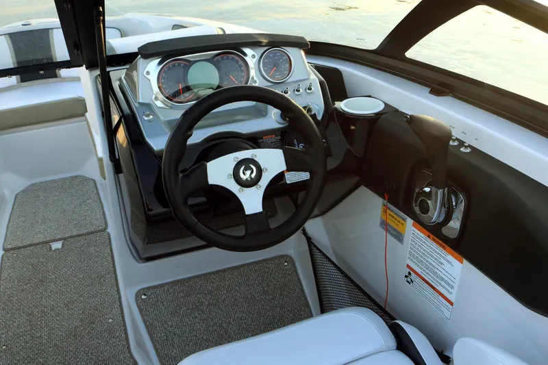 Slide: The Image of 2015 Scarab 215 boat in showroom, red and white exterior, on trailer. - 7