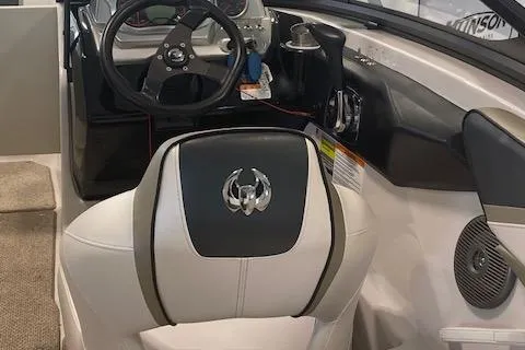 Slide: The Image of 2015 Scarab 215 boat interior with steering wheel and seating. - 8