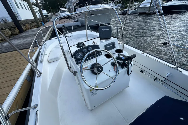 Slide: The Image of 2016 Boston Whaler 170 Montauk boat interior with steering wheel and control panel. - 3
