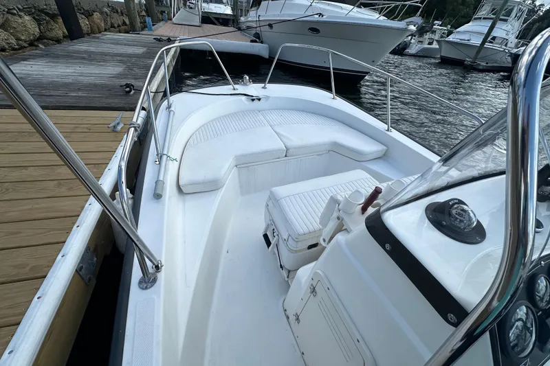 Slide: The Image of 2016 Boston Whaler 170 Montauk boat docked, featuring spacious seating and sleek design. - 4