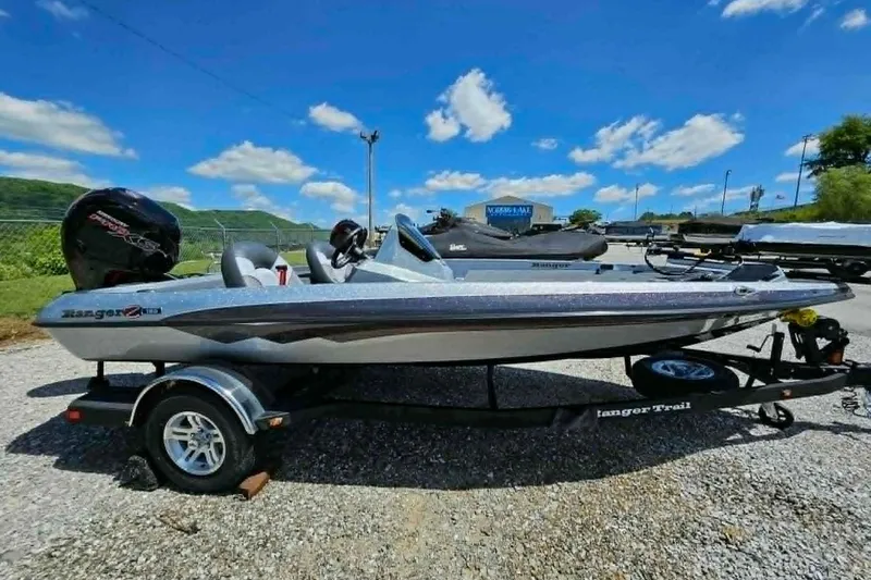 Slide: The Image of 2025 Ranger Z185 boat on trailer under clear blue sky. - 12