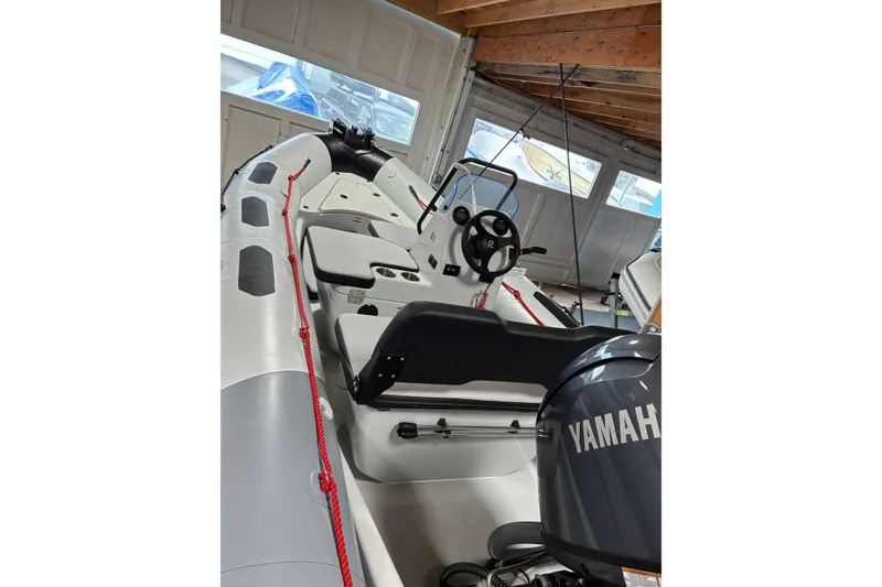 Slide: The Image of 2026 Zodiac Open 4.8 boat with Yamaha engine in a garage setting. - 5