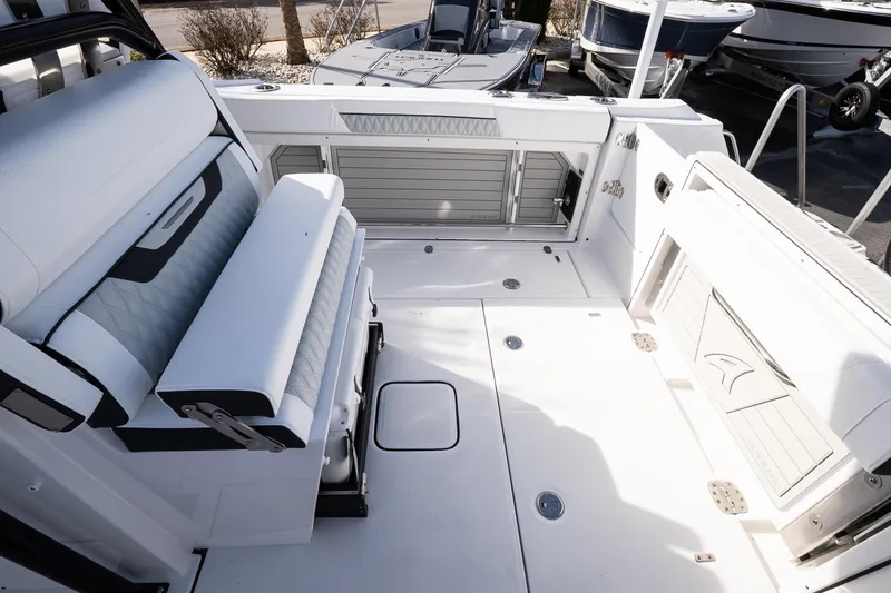 Slide: The Image of 2026 Blackfin 302 CC boat interior with white seating and storage compartments. - 15