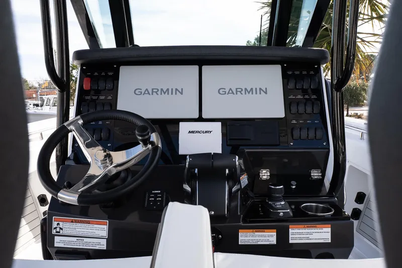 Slide: The Image of 2026 Blackfin 302 CC boat dashboard with Garmin displays and Mercury controls. - 19