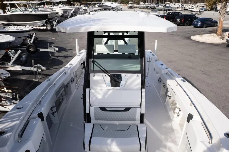 Slide: The Image of 2026 Blackfin 302 CC boat in a marina, showcasing sleek design and spacious deck. - 24
