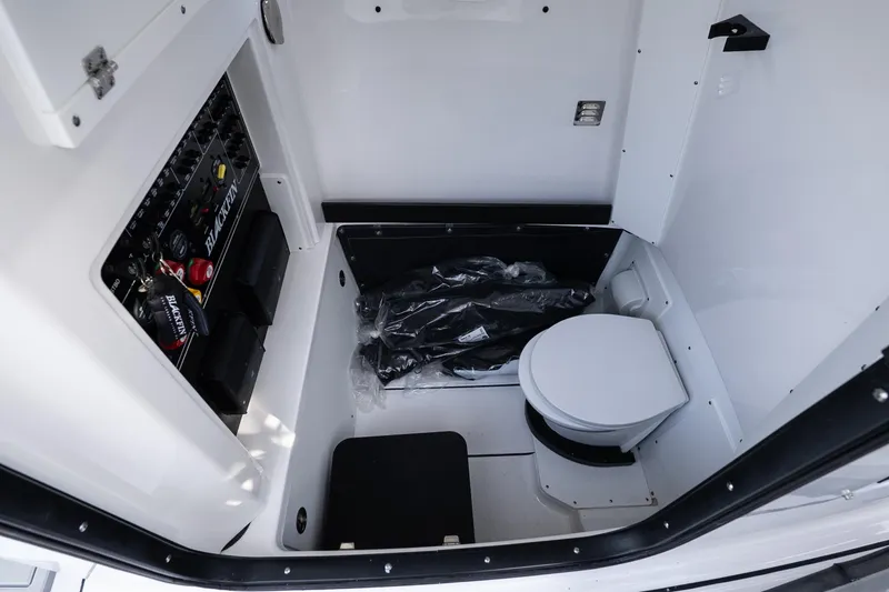 Slide: The Image of 2026 Blackfin 302 CC boat interior with toilet and control panel. - 27