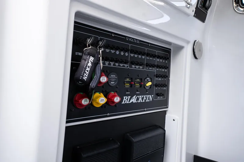 Slide: The Image of Control panel of 2026 Blackfin 302 CC boat with labeled switches and keychain. - 28
