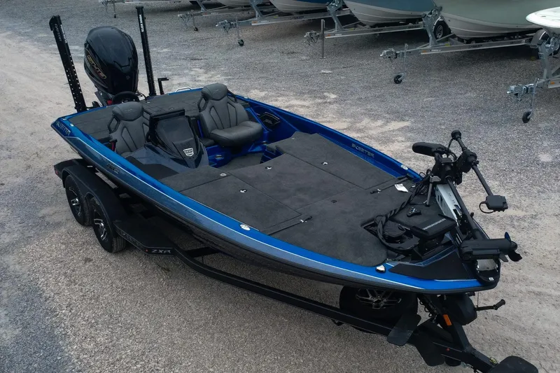 Slide: The Image of 2024 Skeeter ZXR20 fishing boat with blue accents, parked on a trailer. - 0