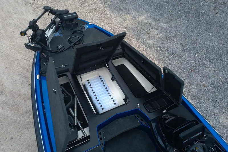 Slide: The Image of 2024 Skeeter ZXR20 boat interior with open storage compartments and fishing equipment. - 10