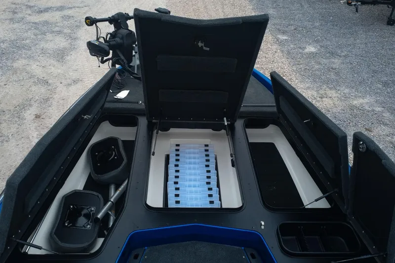Slide: The Image of 2024 Skeeter ZXR20 boat storage compartments with open lids, showcasing organized interior space. - 11