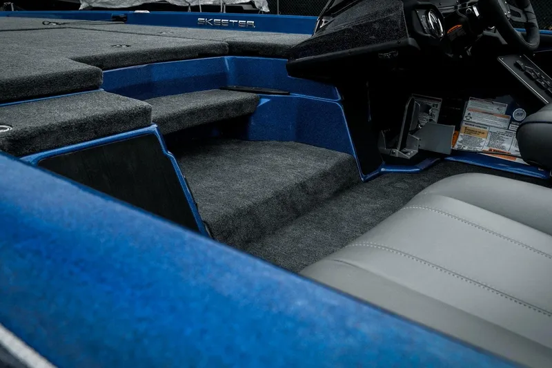 Slide: The Image of 2024 Skeeter ZXR20 boat interior with blue and gray seating, showcasing modern design. - 17