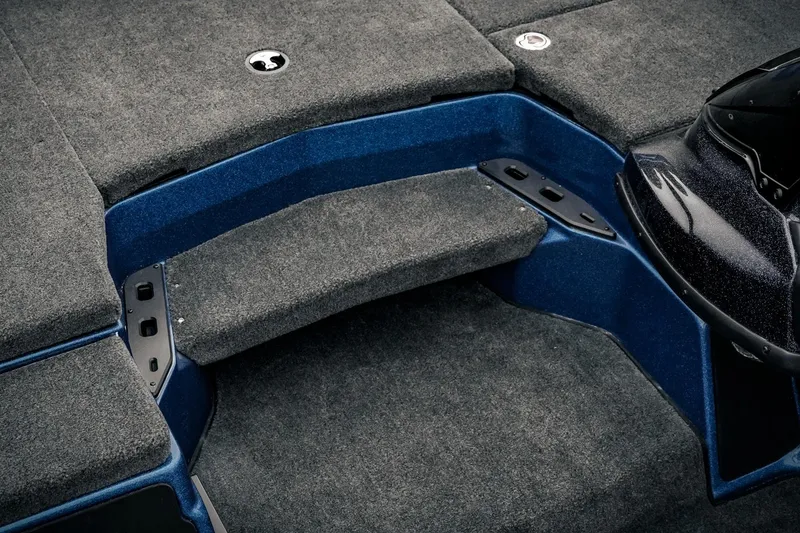 Slide: The Image of 2024 Skeeter ZXR20 boat interior with carpeted steps and blue accents. - 6