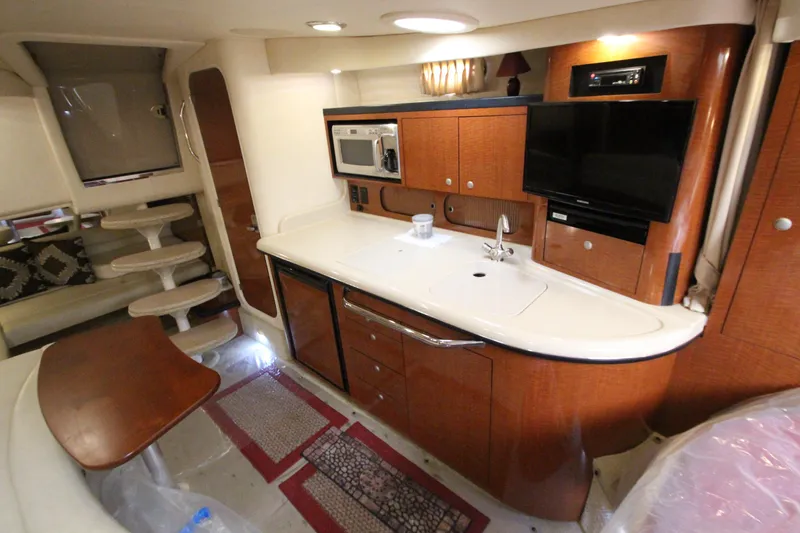 Slide: The Image of 2005 Sea Ray 340 Sundancer interior with kitchenette, TV, and seating area. - 11