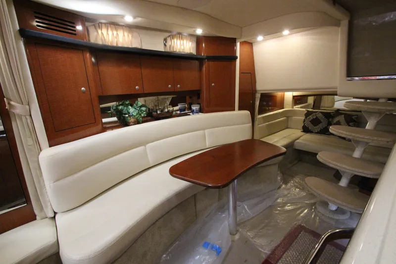 Slide: The Image of Luxurious interior of 2005 Sea Ray 340 Sundancer yacht with elegant seating and wooden cabinetry. - 13