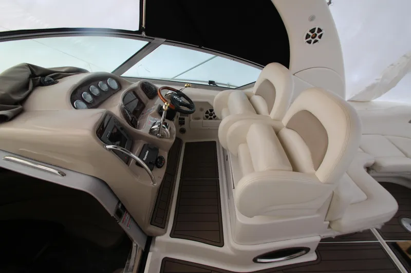 Slide: The Image of 2005 Sea Ray 340 Sundancer helm with dual seats and modern controls. - 23