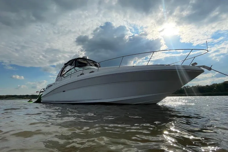 Slide: The Image of 2005 Sea Ray 340 Sundancer yacht anchored on a sunny day with cloudy skies. - 3
