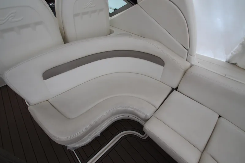 Slide: The Image of 2005 Sea Ray 340 Sundancer interior seating with white upholstery and curved design. - 30