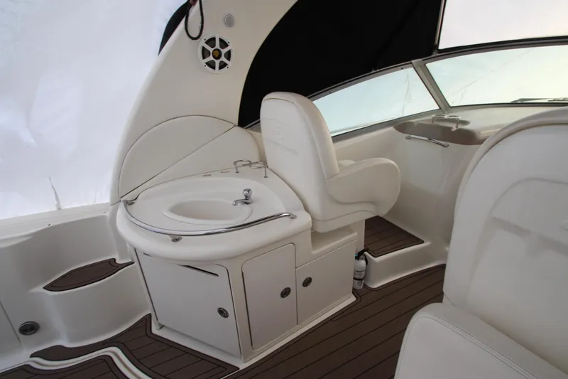Slide: The Image of 2005 Sea Ray 340 Sundancer interior with helm seat and sink, featuring sleek design. - 31