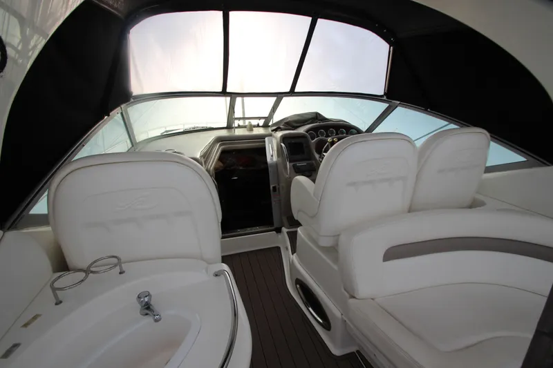 Slide: The Image of Interior of 2005 Sea Ray 340 Sundancer boat with white seating and helm controls. - 33