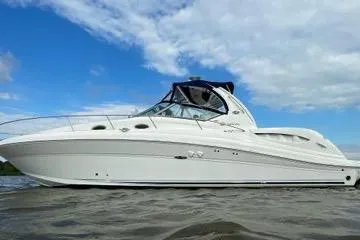 Slide: The Image of 2005 Sea Ray 340 Sundancer yacht on water under blue sky. - 4