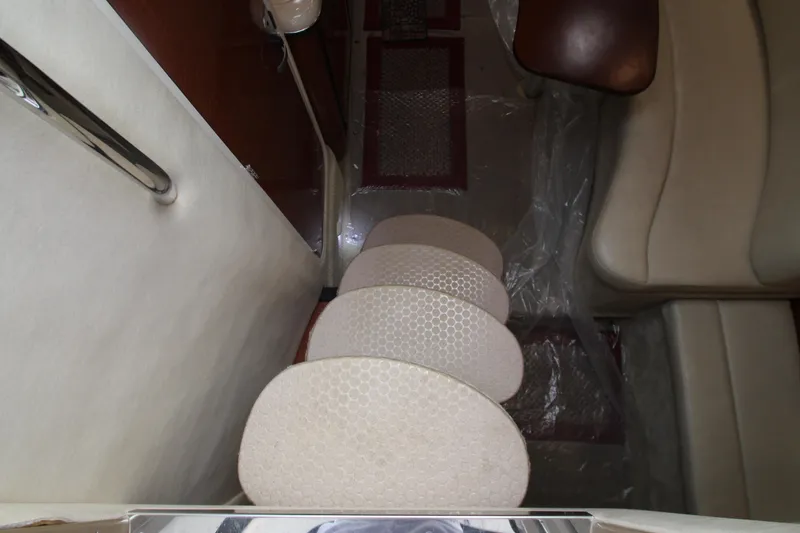Slide: The Image of Interior stairs of 2005 Sea Ray 340 Sundancer yacht, featuring beige upholstery and sleek design. - 6