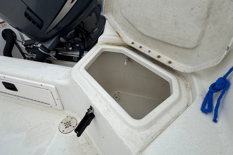 Slide: The Image of 2007 Hydra-Sports Lightning 180 CC boat storage compartment with open lid and visible engine. - 10