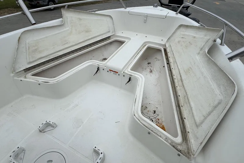 Slide: The Image of 2007 Hydra-Sports Lightning 180 CC boat with open storage compartments on deck. - 13