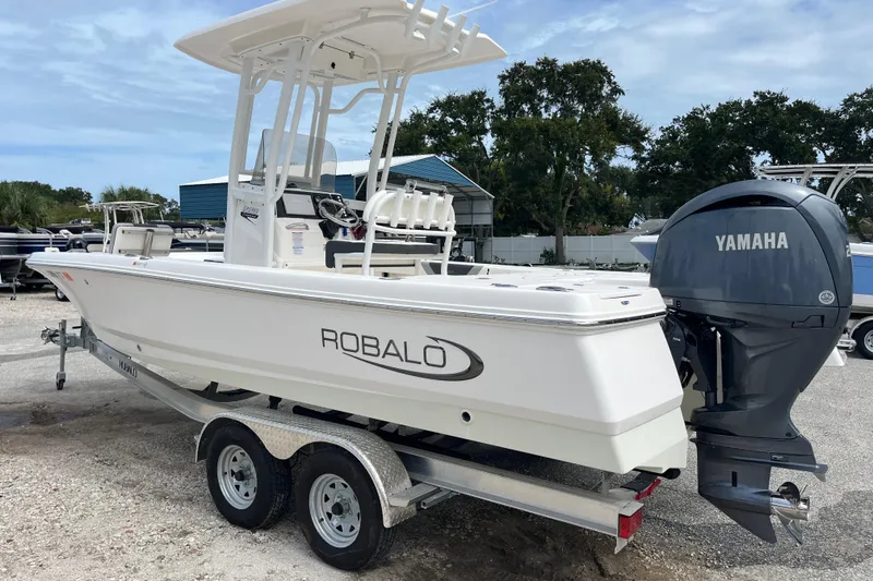 Slide: The Image of 2024 Robalo 226 Cayman boat with Yamaha engine on trailer, parked outdoors. - 4