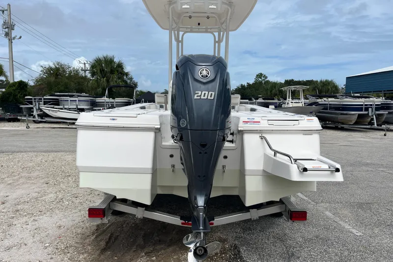 Slide: The Image of 2024 Robalo 226 Cayman boat with Yamaha 200 engine, parked on a trailer. - 5