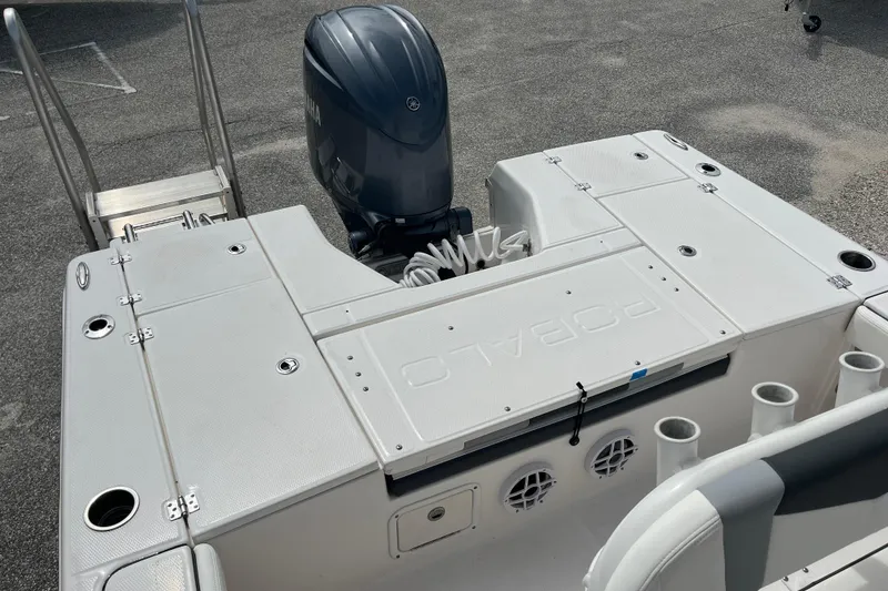 Slide: The Image of 2024 Robalo 226 Cayman boat deck with Yamaha outboard motor, featuring storage compartments. - 8