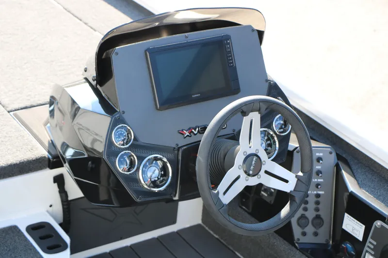 Slide: The Image of 2025 Vexus AVX 1985s boat dashboard with steering wheel and digital display. - 14