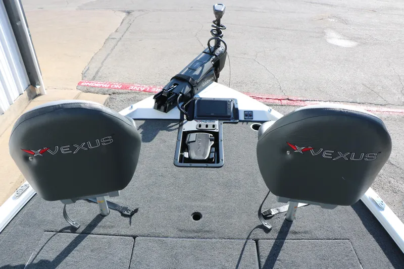 Slide: The Image of 2025 Vexus AVX 1985s boat interior with dual seats and Garmin equipment. - 25