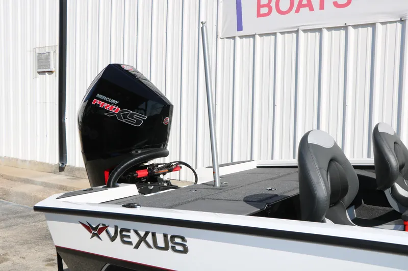 Slide: The Image of 2025 Vexus AVX 1985s boat with Mercury Pro XS engine, parked near a building. - 36