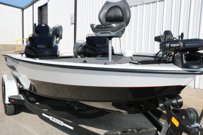 Slide: The Image of 2025 Vexus AVX 1985s boat with modern seating and equipment, parked outside a warehouse. - 5