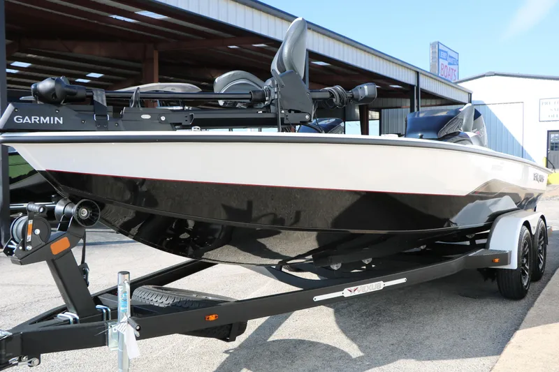 Slide: The Image of 2025 Vexus AVX 1985s boat on trailer, featuring Garmin equipment, parked outdoors. - 6