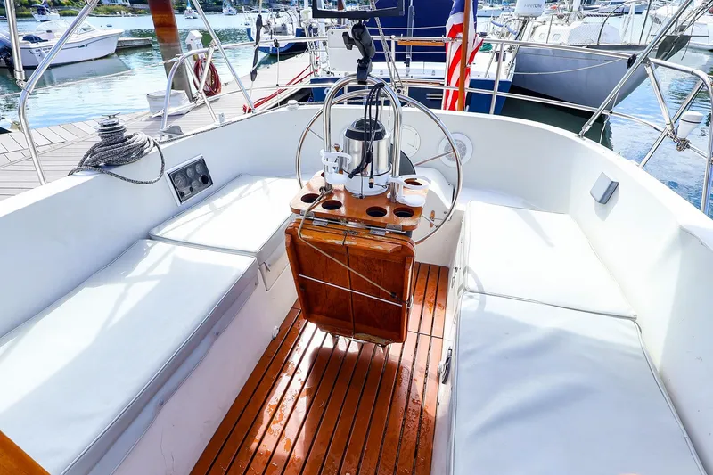 Slide: The Image of Cockpit of 1988 Nonsuch 30 Ultra sailboat with wooden flooring and seating. - 1