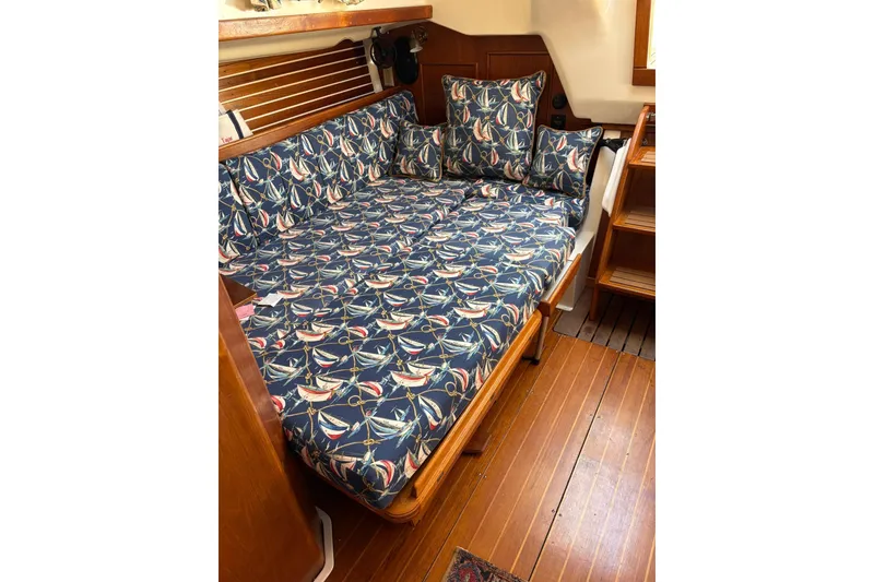 Slide: The Image of 1988 Nonsuch 30 Ultra interior with nautical-themed cushions and wooden flooring. - 12