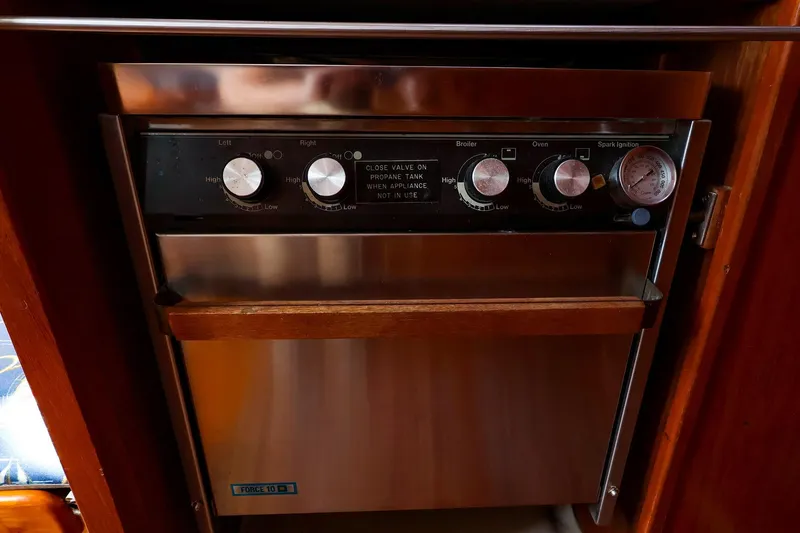 Slide: The Image of Stainless steel oven with control knobs in a 1988 Nonsuch 30 Ultra yacht. - 14