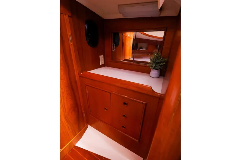 Slide: The Image of Interior of 1988 Nonsuch 30 Ultra sailboat with wooden cabinetry and mirror. - 16