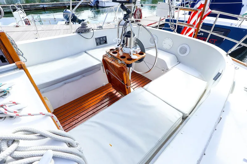 Slide: The Image of Cockpit of 1988 Nonsuch 30 Ultra sailboat with wooden flooring and cushioned seating. - 2