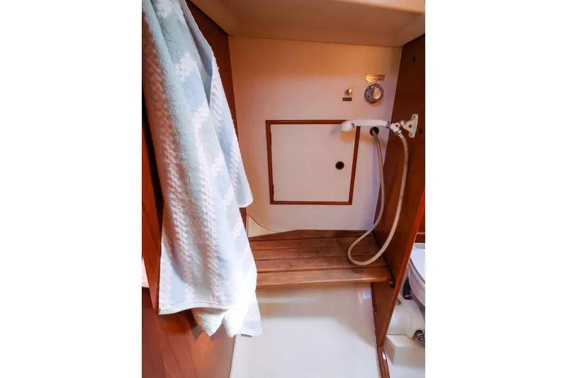 Slide: The Image of Shower area in 1988 Nonsuch 30 Ultra sailboat with wooden bench and towel. - 20