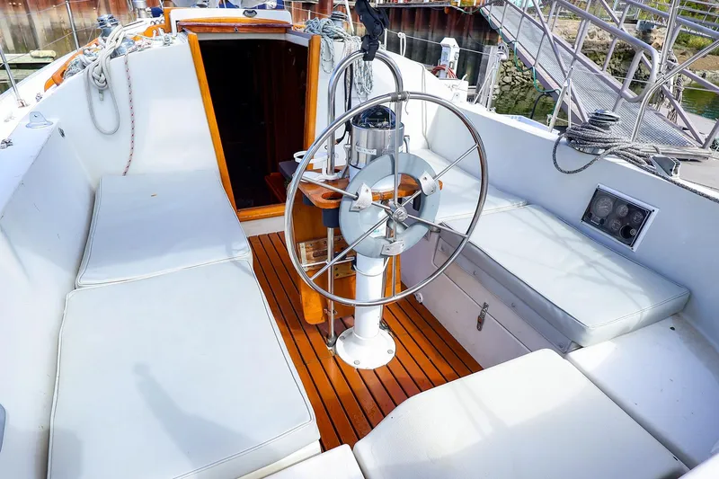 Slide: The Image of Cockpit of 1988 Nonsuch 30 Ultra sailboat with wooden flooring and steering wheel. - 3