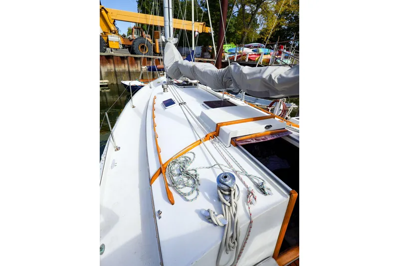Slide: The Image of 1988 Nonsuch 30 Ultra sailboat deck with rigging and covered boom in marina. - 4