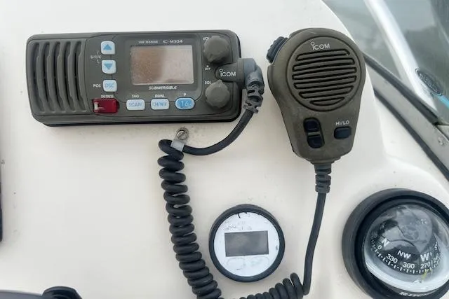 Slide: The Image of Control panel of a 2008 Scout 242 Dorado boat with radio and compass. - 10