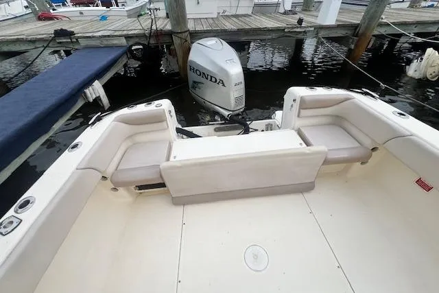 Slide: The Image of 2008 Scout 242 Dorado boat with Honda outboard motor, docked at marina. - 11