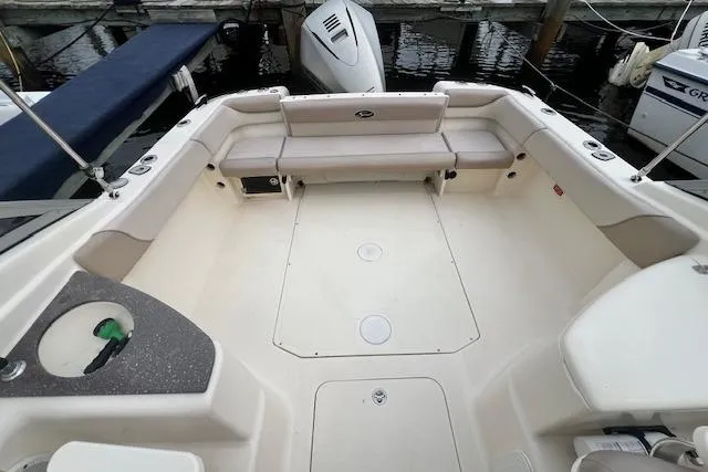 Slide: The Image of 2008 Scout 242 Dorado boat interior with seating and motor at dock. - 12